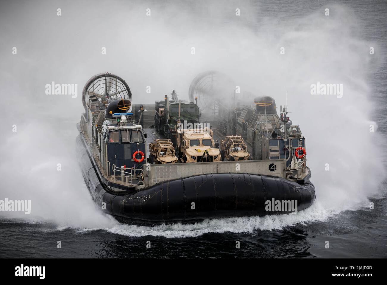 BALTIC SEA (May 20, 2022) – Landing Craft, Air Cushion 04, attached to Assault Craft Unit 4, approaches the Wasp-class amphibious assault ship USS Kearsarge (LHD 3) May 20, 2022. Kearsarge, flagship of the Kearsarge Amphibious Ready Group and embarked 22nd Marine Expeditionary Unit, is participating in the Estonian-led exercise Siil 22 (Hedgehog 22 in English). Hedgehog 22 brings together members of the Estonian Defense Force and U.S. Sailors and Marines under Task Force 61/2 to enhance Allied interoperability and preserve security and stability in the Baltic region. (U.S. Navy photo by Mass C Stock Photo