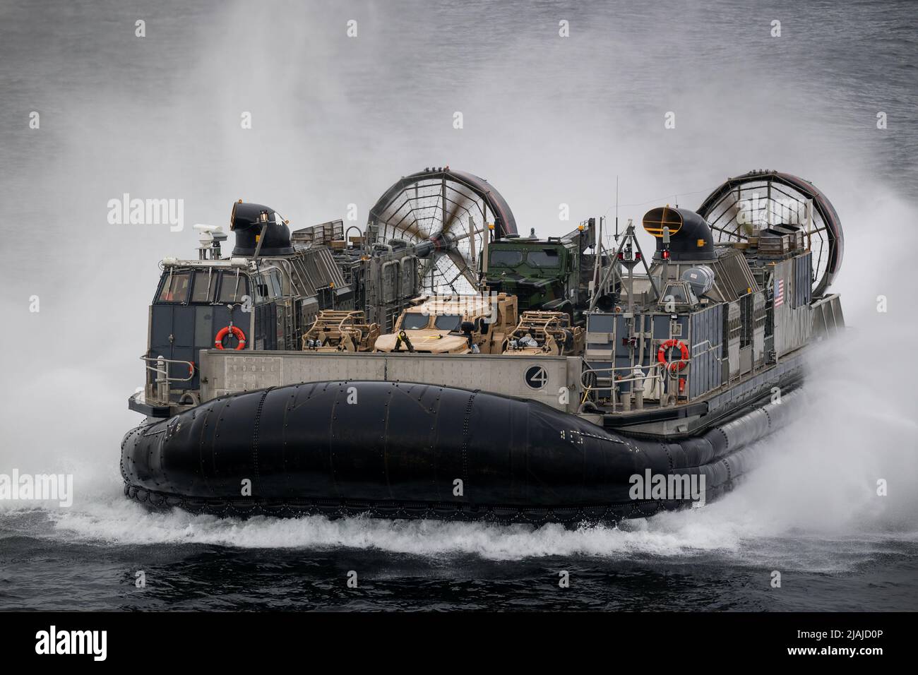 BALTIC SEA (May 20, 2022) – Landing Craft, Air Cushion 04, attached to Assault Craft Unit 4, approaches the Wasp-class amphibious assault ship USS Kearsarge (LHD 3) May 20, 2022. Kearsarge, flagship of the Kearsarge Amphibious Ready Group and embarked 22nd Marine Expeditionary Unit, is participating in the Estonian-led exercise Siil 22 (Hedgehog 22 in English). Hedgehog 22 brings together members of the Estonian Defense Force and U.S. Sailors and Marines under Task Force 61/2 to enhance Allied interoperability and preserve security and stability in the Baltic region. (U.S. Navy photo by Mass C Stock Photo
