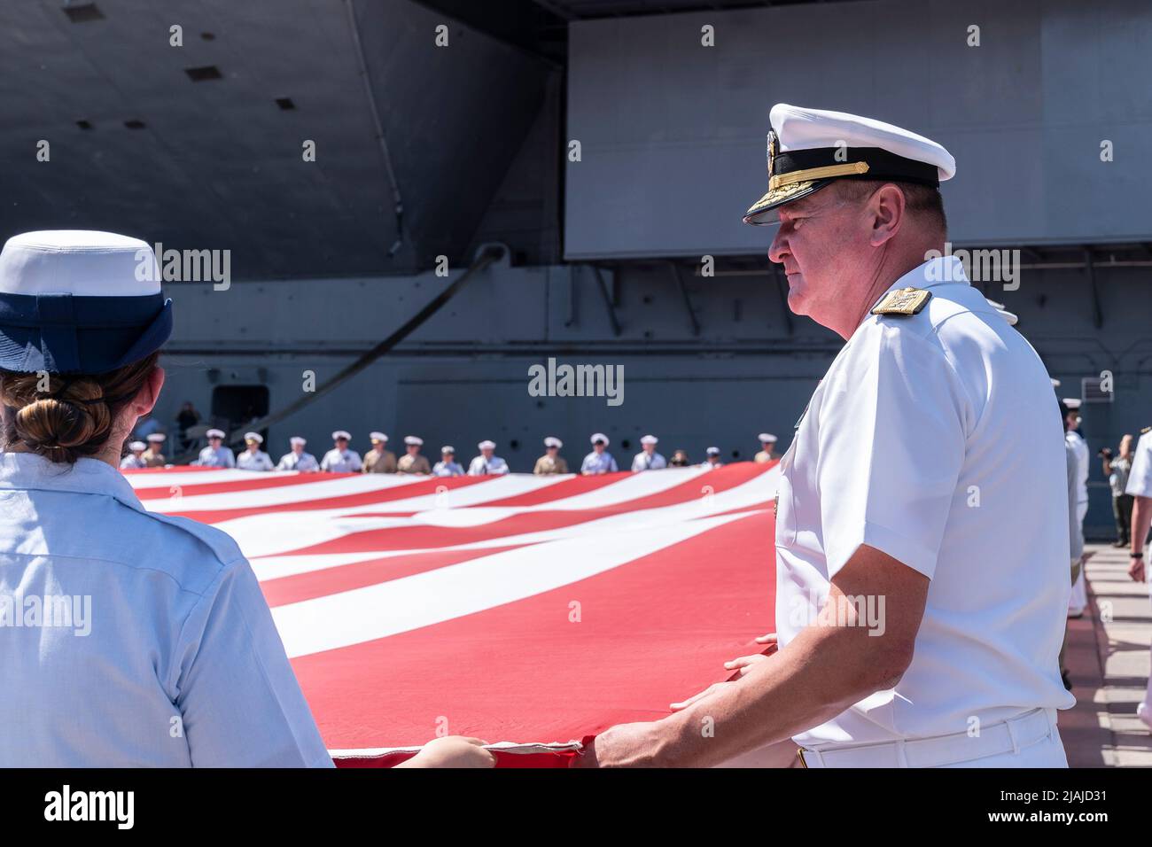 New York, US May 30, 2022. Rear Admiral Charles Rock helps unfurle huge American flag during the