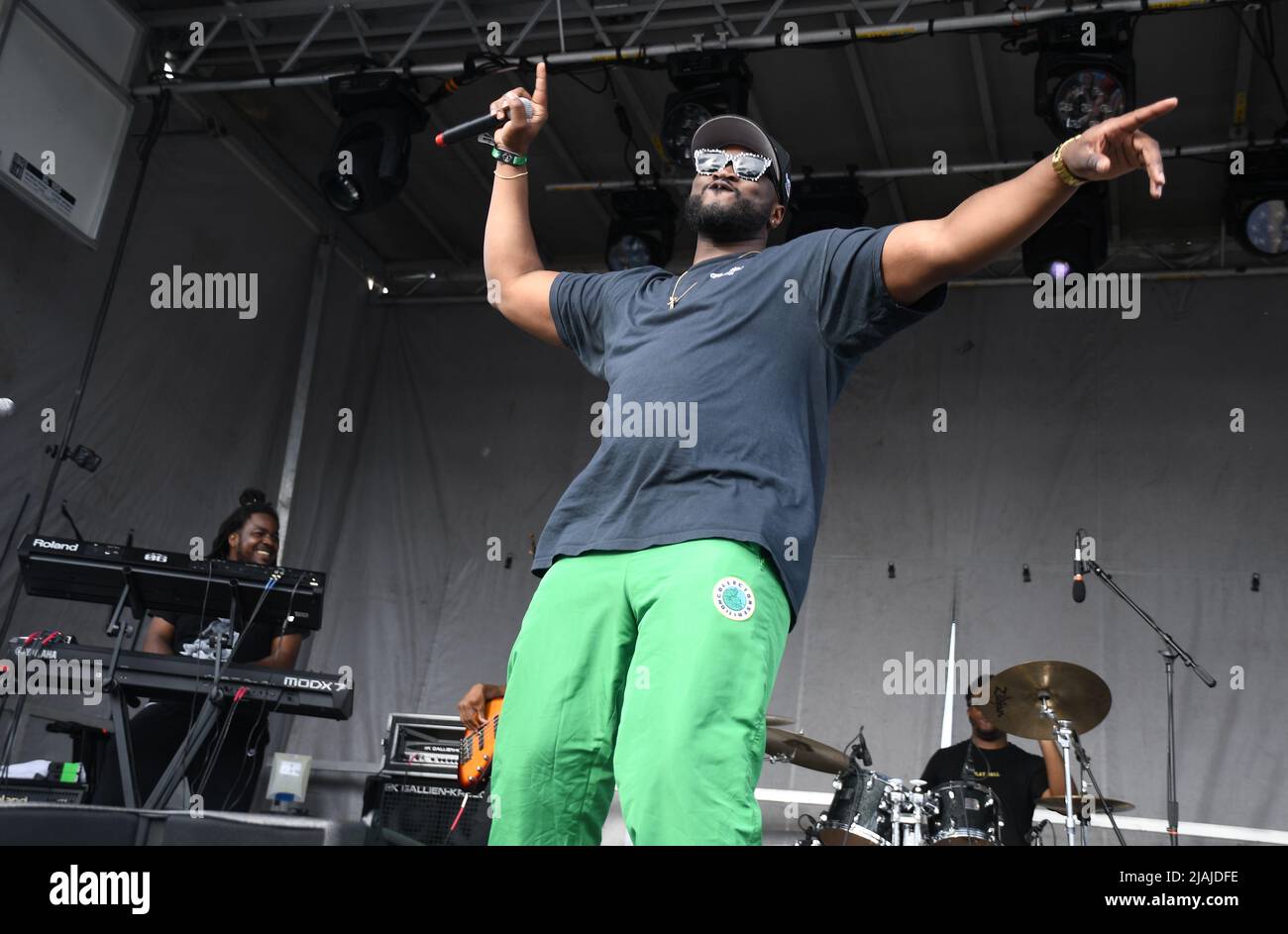 Rapper Avenue is shown performing on stage during a live concert ...