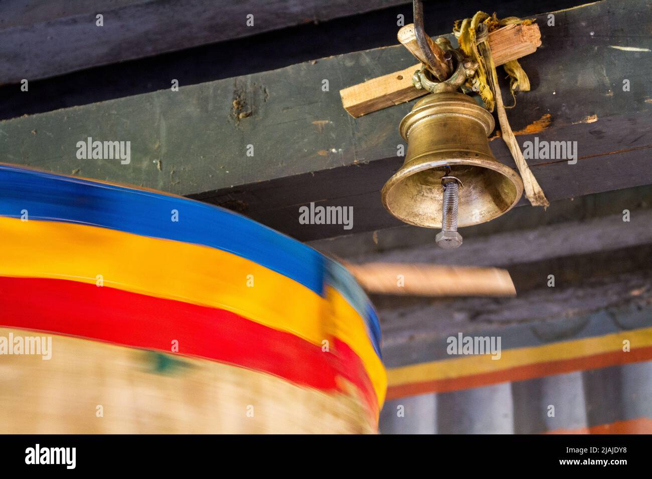 A spinning Buddhist prayer wheel rings a bell - Unnamed Road, , Bumthang, Bhutan (BT) Stock Photo