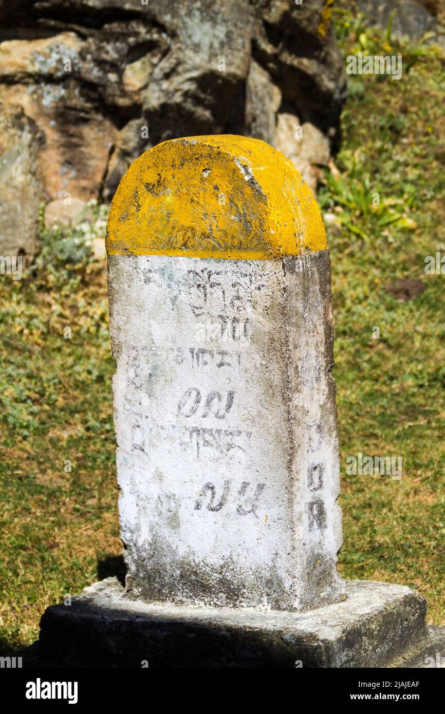 Mileage marker along the road in Bhutan Stock Photo