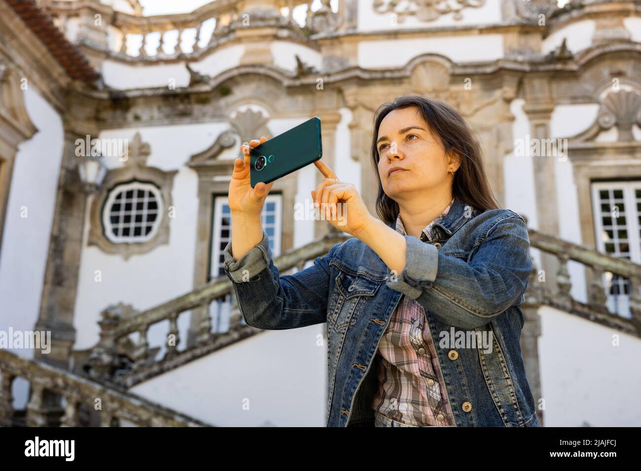 Woman photographing with her smartphone at Mateus Palace in Vila Real Stock Photo