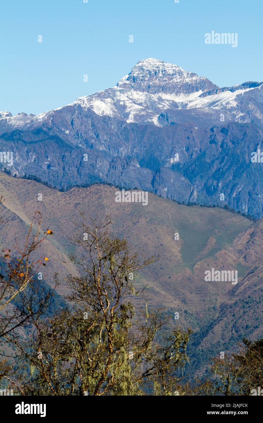 Distant Himalayan Peaks are seen from the roadside in rural Bhutan Stock Photo