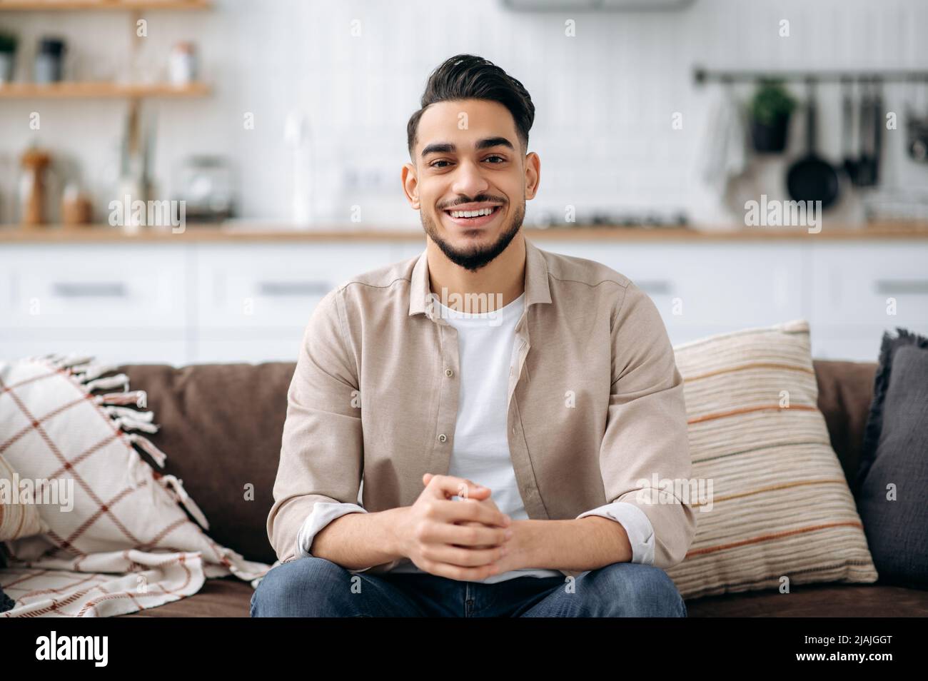 Man sitting couch smiling hi-res stock photography and images - Alamy
