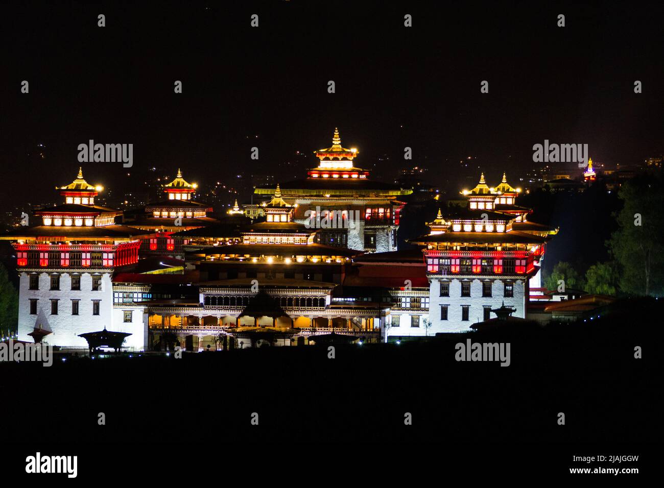 Kingdom of Bhutan's Dechencholing Palace or Royal Palace in the capitol city of Thimphu as seen lit at night Stock Photo