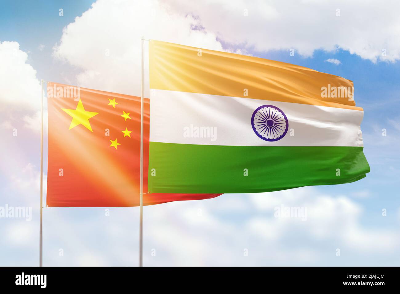 Sunny blue sky and flags of india and china Stock Photo