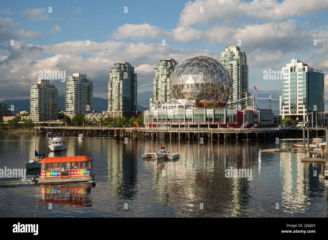 Vancouver Science World at the end of False Creek with yachts moored in the harbour. Stock Photo