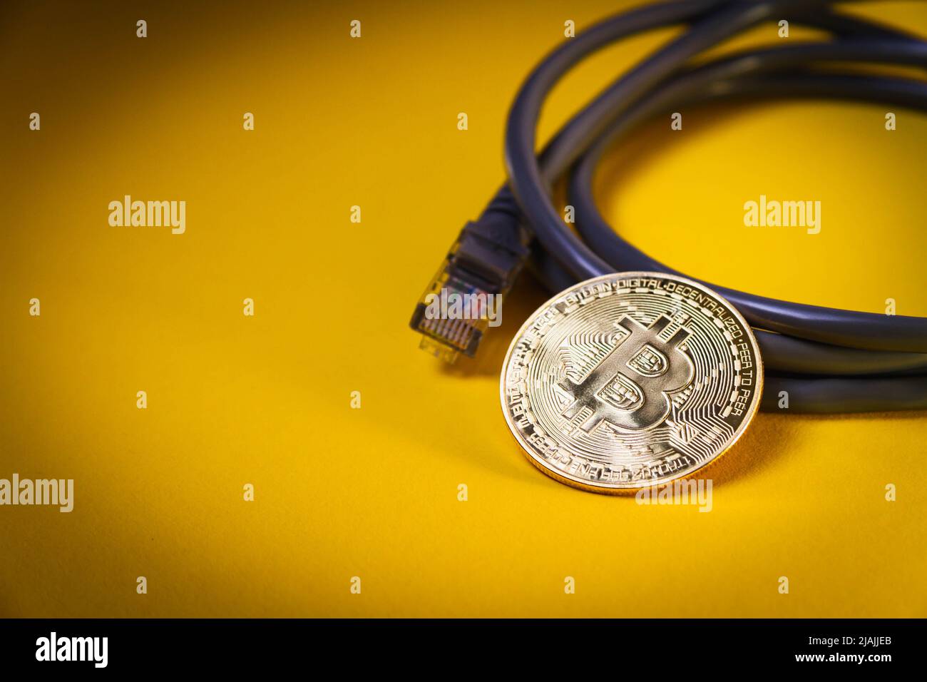 Internet payment for bitcoins. Internet cable and coin. Cryptocurrency as a  means of payment. Bitcoin coin close up Stock Photo - Alamy