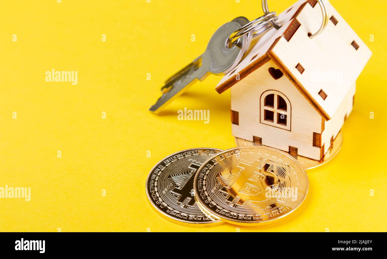 Buying real estate for cryptocurrency. Housing and bitcoins. Coins and  house keys. Small wooden house and bitcoin coin Stock Photo - Alamy