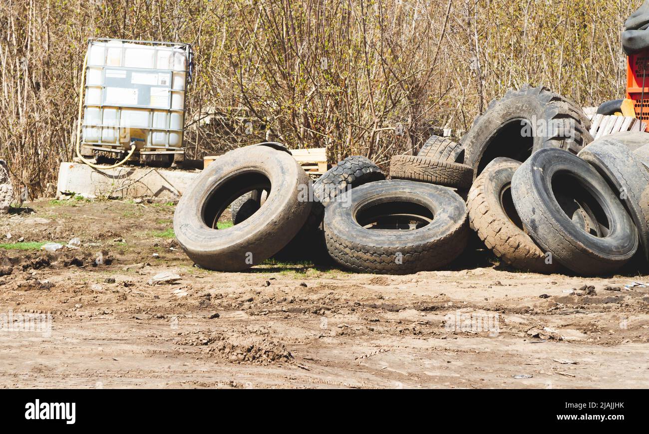 Changing car tires. Old rubber tires in the trash. Car dump. Garbage