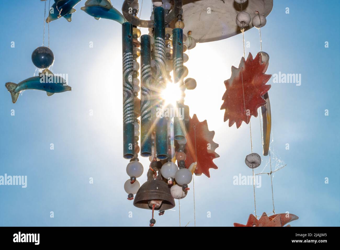 A chimes hanging against the blue sky with sun Stock Photo