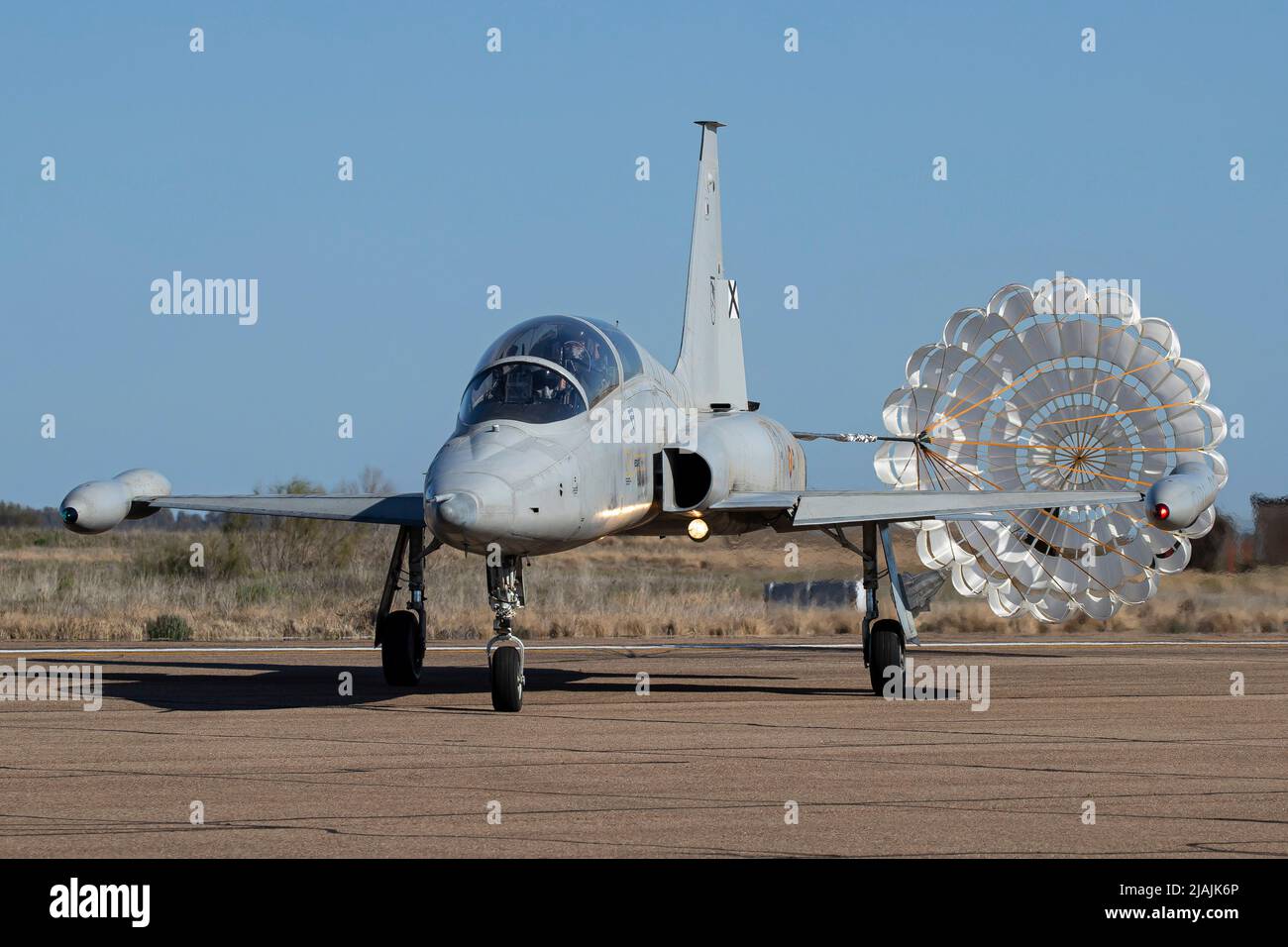 A Spanish Air Force SF-5M Freedom Fighter training jet with its brake chute deployed. Stock Photo