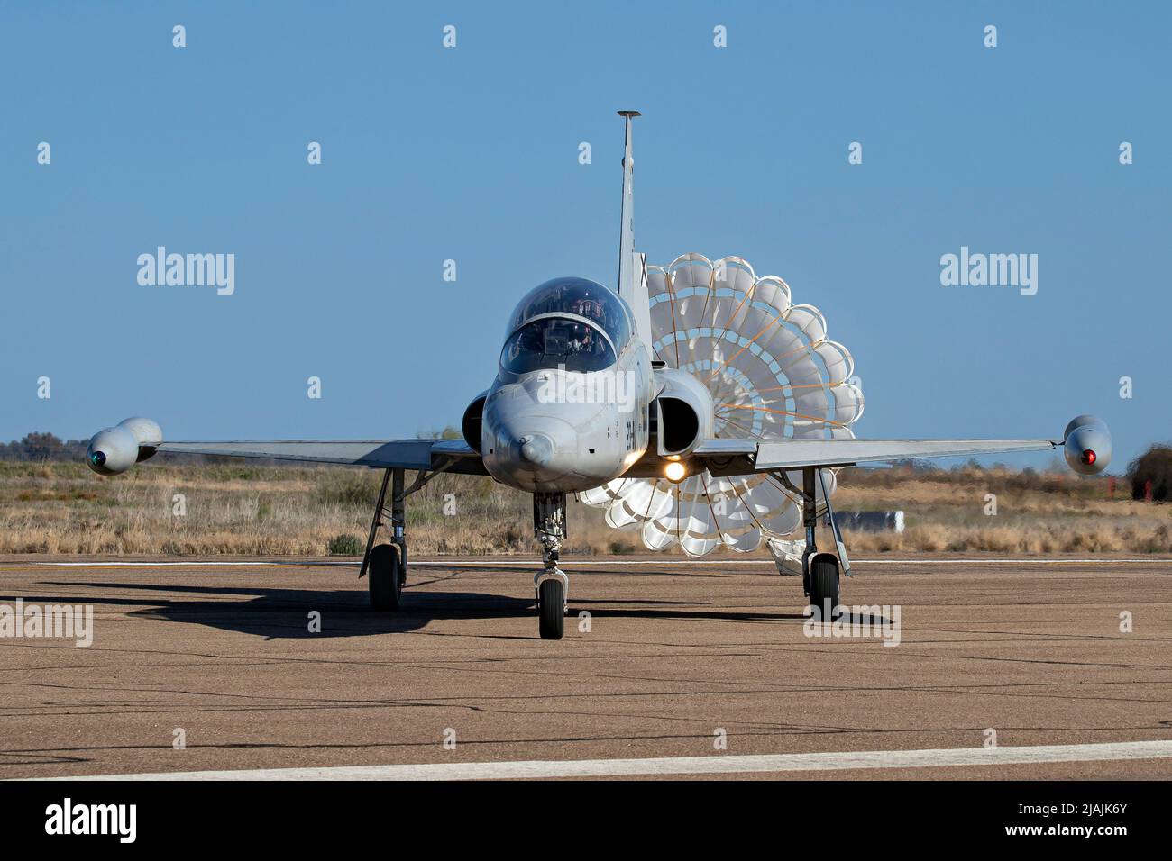 A Spanish Air Force SF-5M Freedom Fighter training jet with its brake chute deployed. Stock Photo