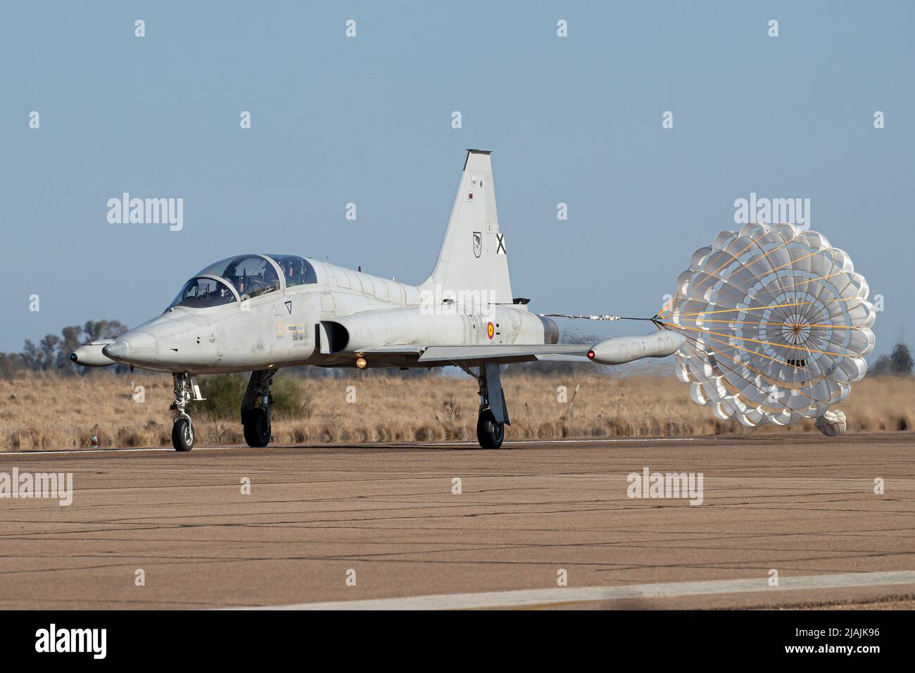 A Spanish Air Force SF-5M Freedom Fighter training jet with its brake chute deployed. Stock Photo