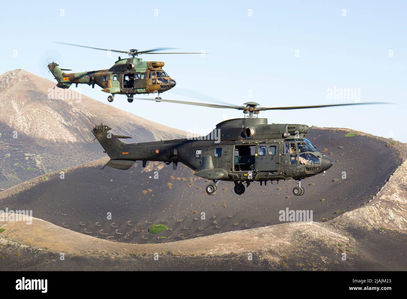 A pair of Spanish Army AS332 Super Pumas in flight over the island of Lanzarote. Stock Photo