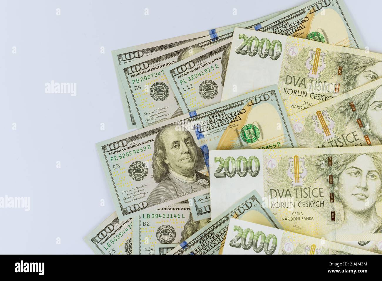 Czech korunas CZK banknotes money currency and hundred dollar bill Stock Photo