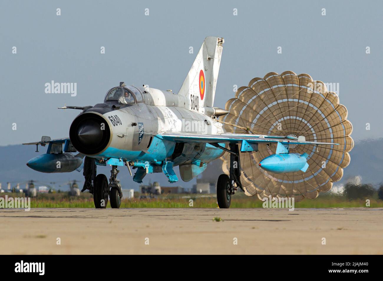 A Romanian Air Force MiG-21 LanceR landing with its brake chute deployed, Campia Turzii, Romania. Stock Photo