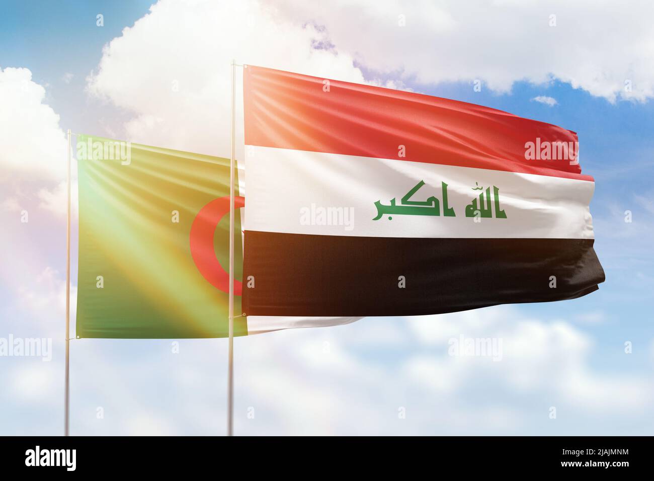 Sunny blue sky and flags of iraq and algeria Stock Photo