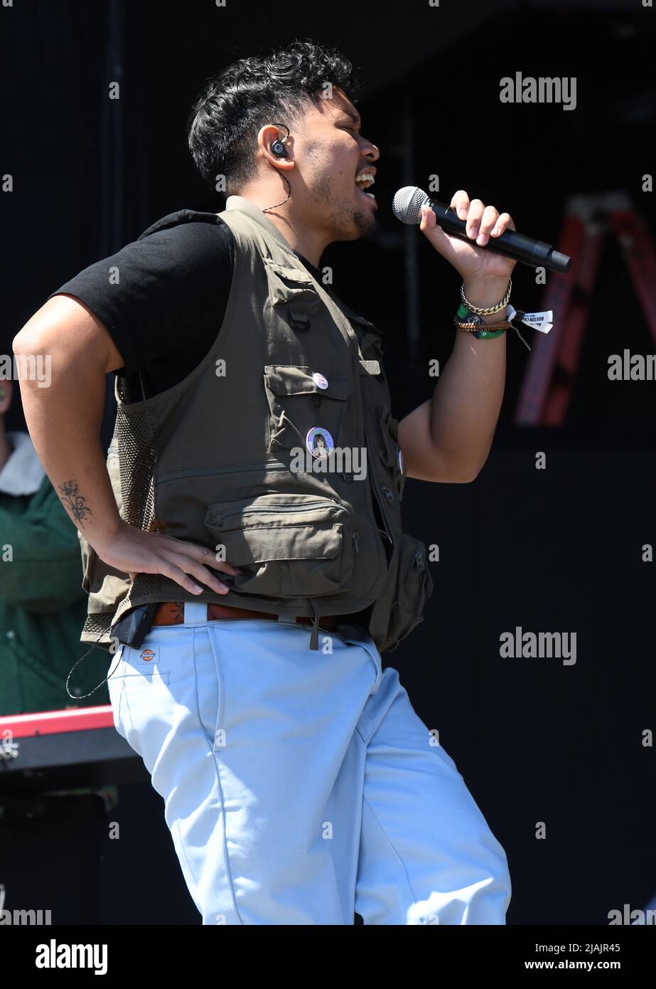 Singer Tarrek AbdelKhaliq is shown performing on stage during a live