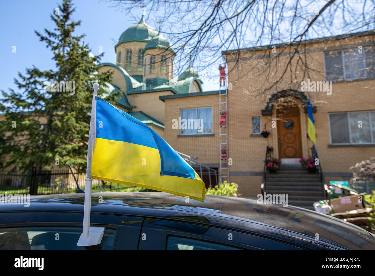 An Ukrainian flag on a car outside the Ukrainian Orthodox Church in Montreal. As the war in