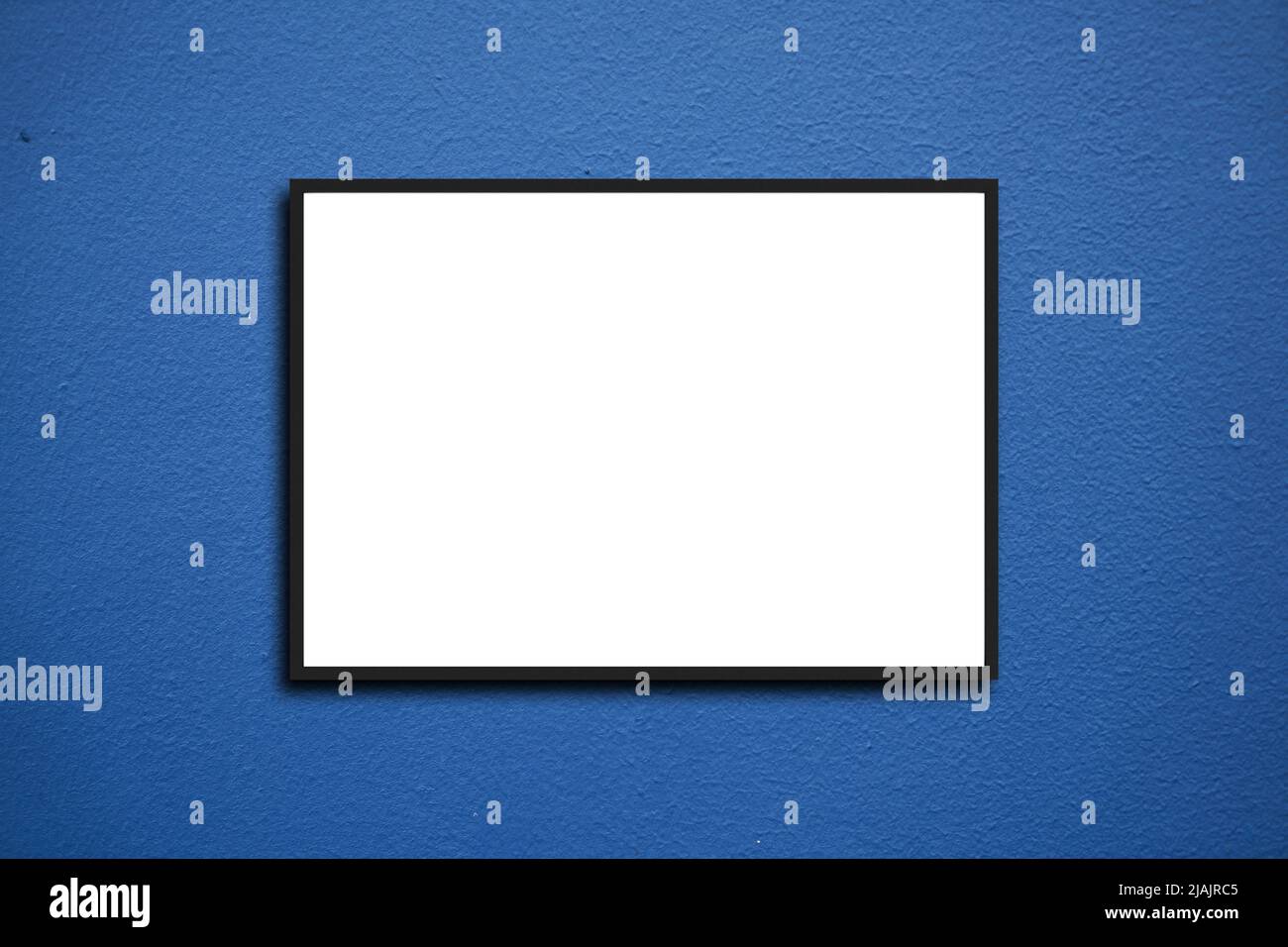 Empty frame. Blank black mounted portrait frame on white brick wall Stock Photo