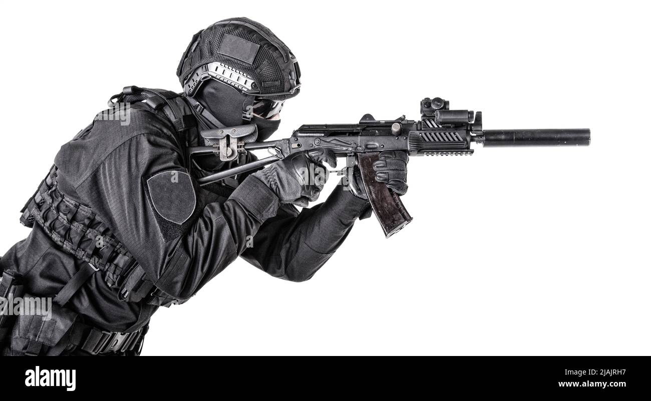 SWAT team shooter aiming with assault rifle, isolated on white background. Stock Photo