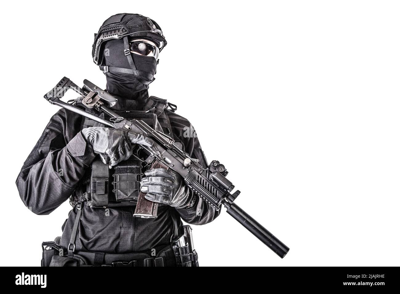 Studio portrait of police special reaction team member black uniform and helmet, armed with assault rifle. Stock Photo
