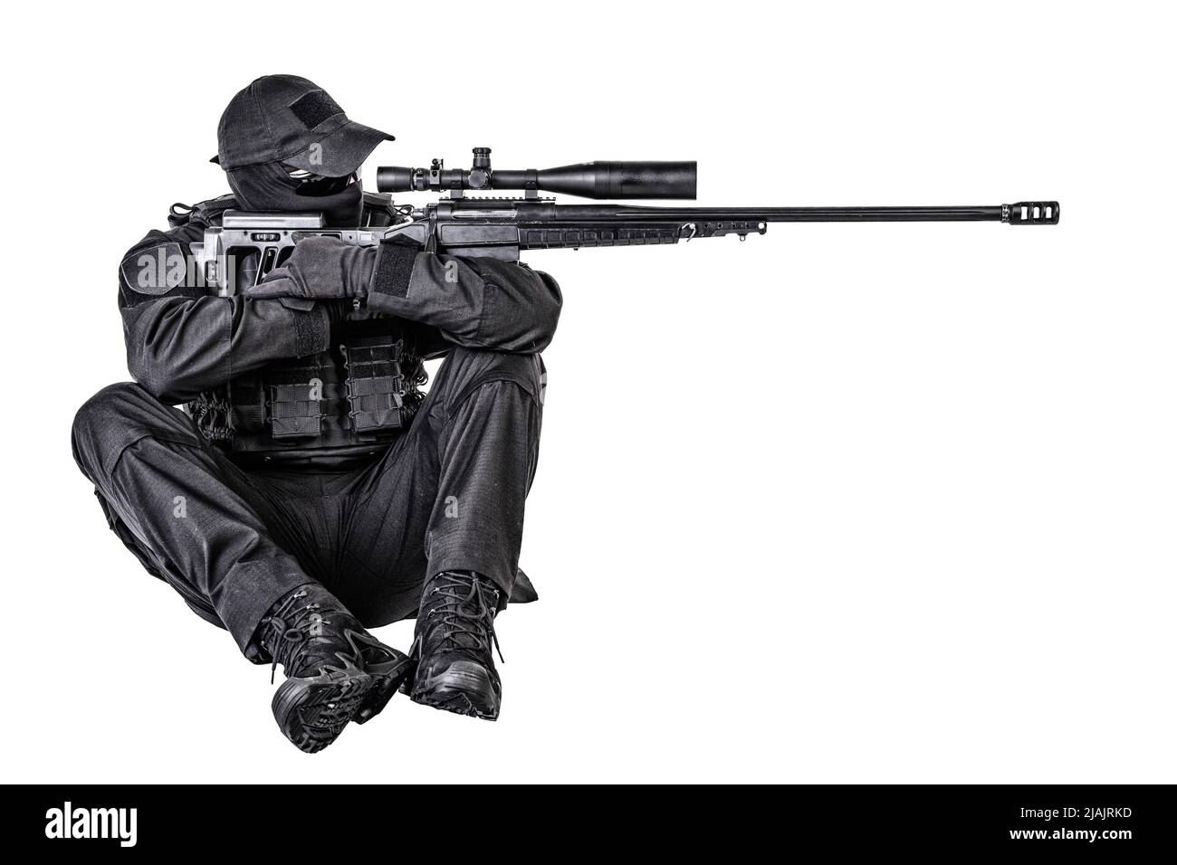 SWAT team sniper sitting and aiming with sniper rifle equipped telescopic optical sight. Stock Photo