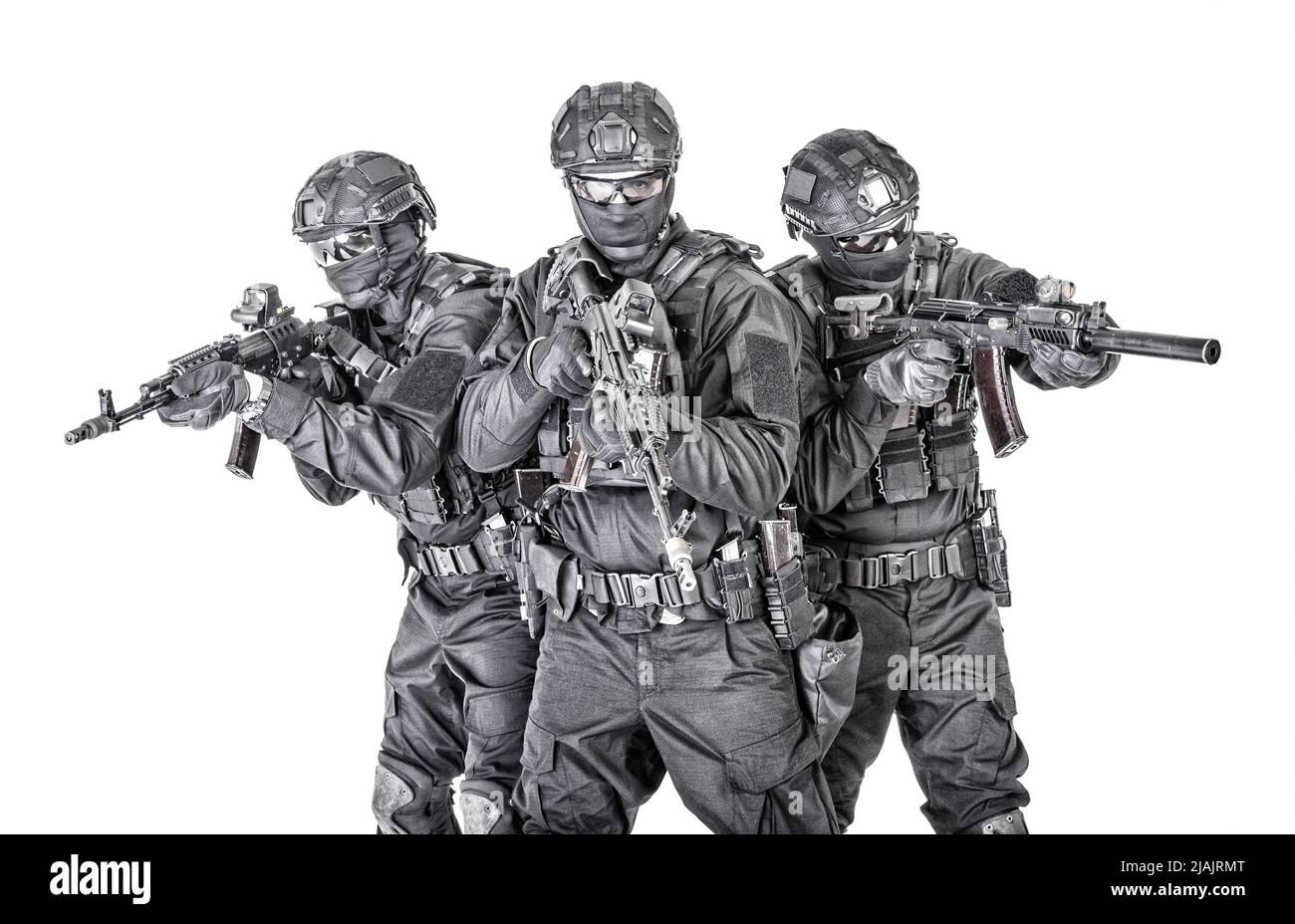 Group of SWAT team fighters in black uniforms, armed with assault rifles isolated on white background. Stock Photo