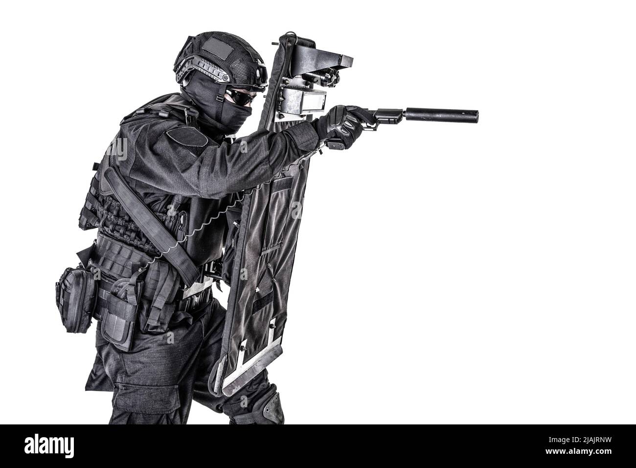 SWAT team fighter hiding behind ballistic shield and aiming pistol. Stock Photo
