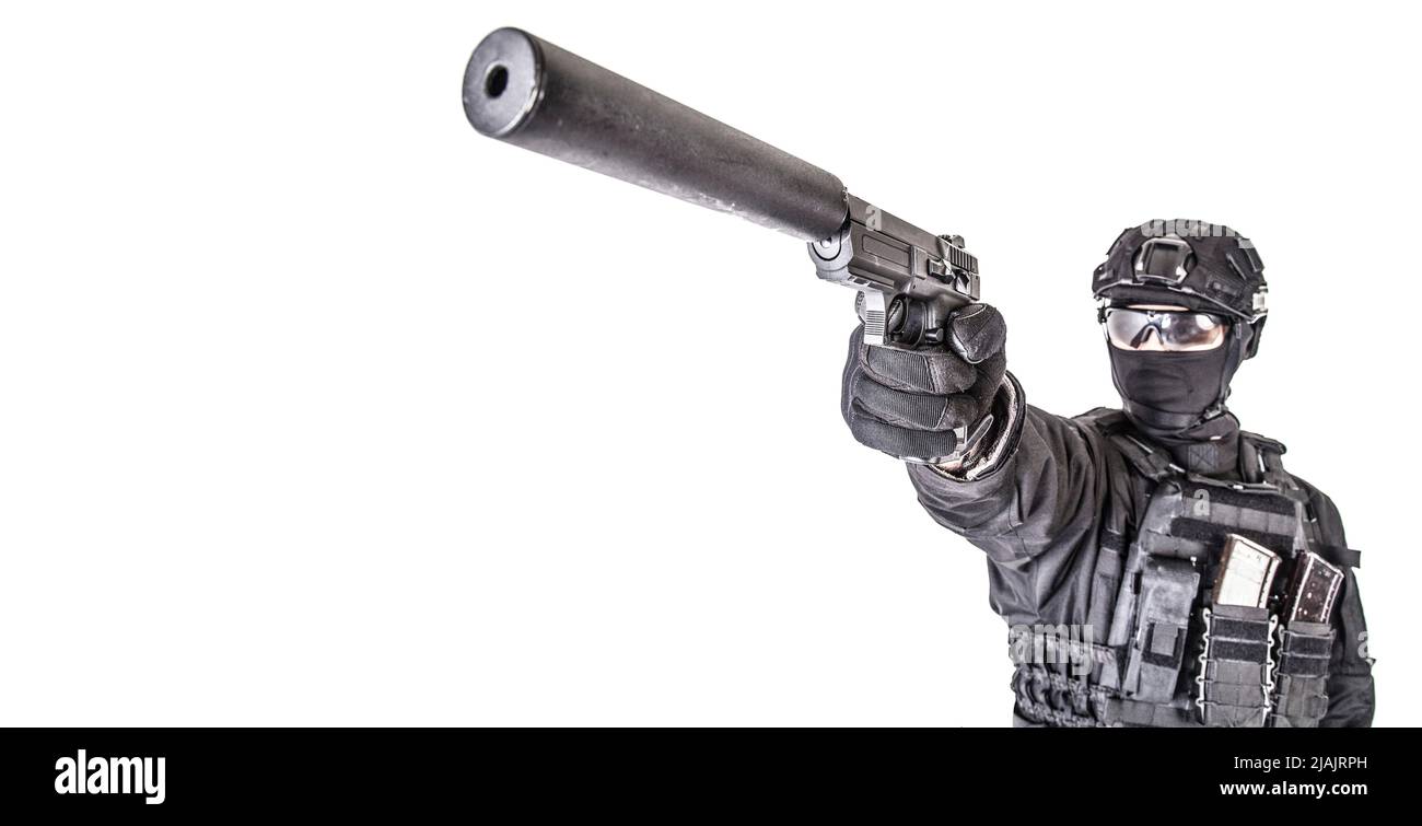 Studio portrait of SWAT officer aiming pistol with silencer on gun barrel. Stock Photo