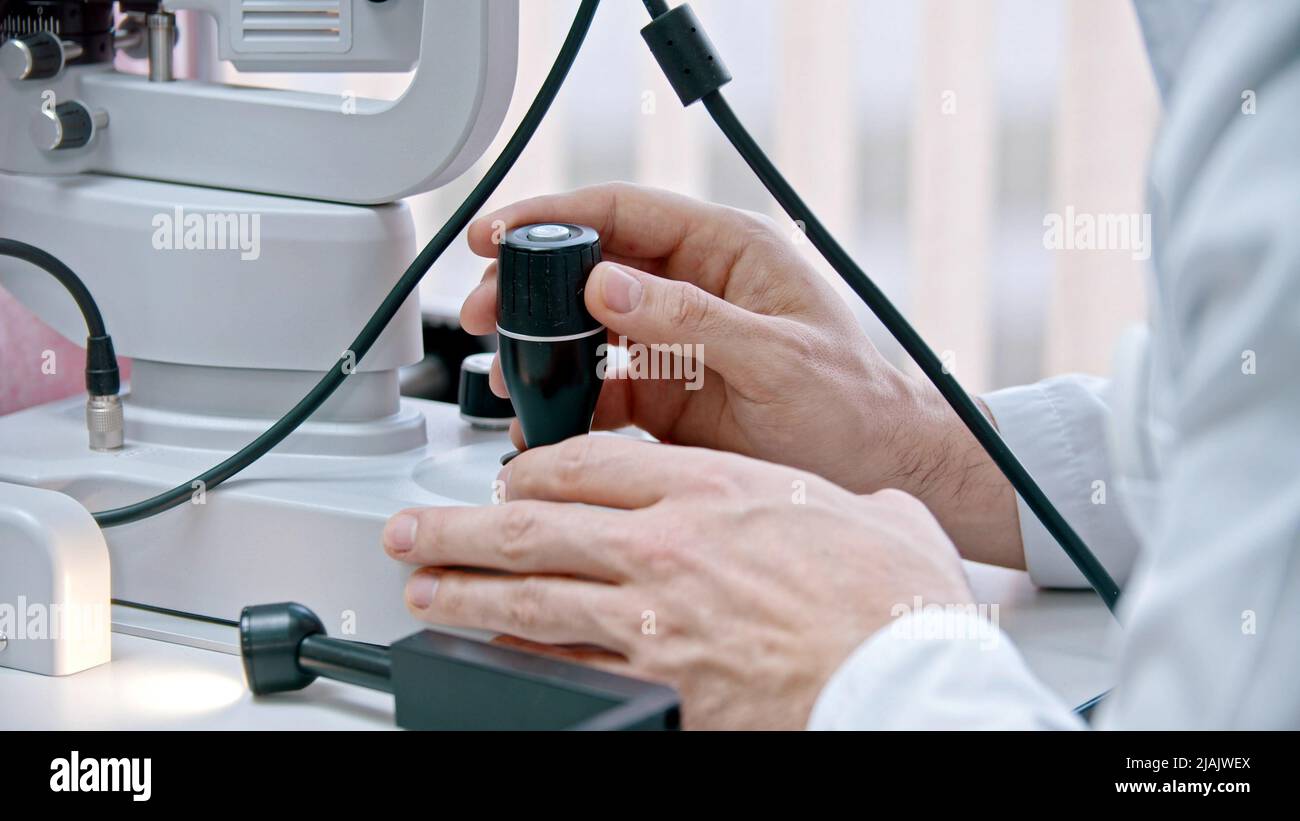 Ophthalmology treatment - a young woman checking her visual acuity with ...