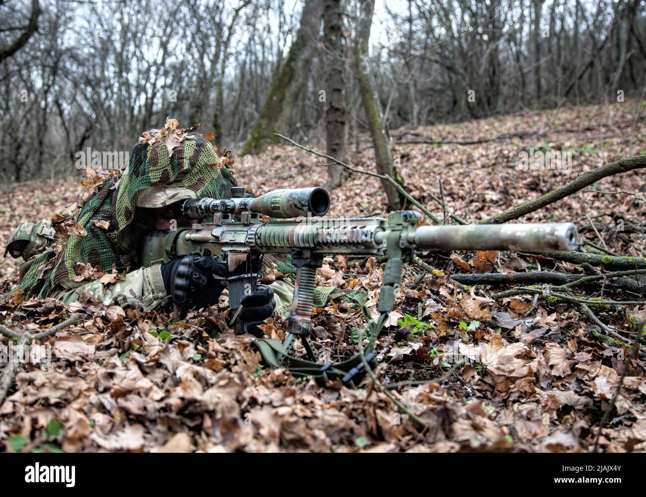 camouflaged sniper rifle with scope Stock Photo - Alamy