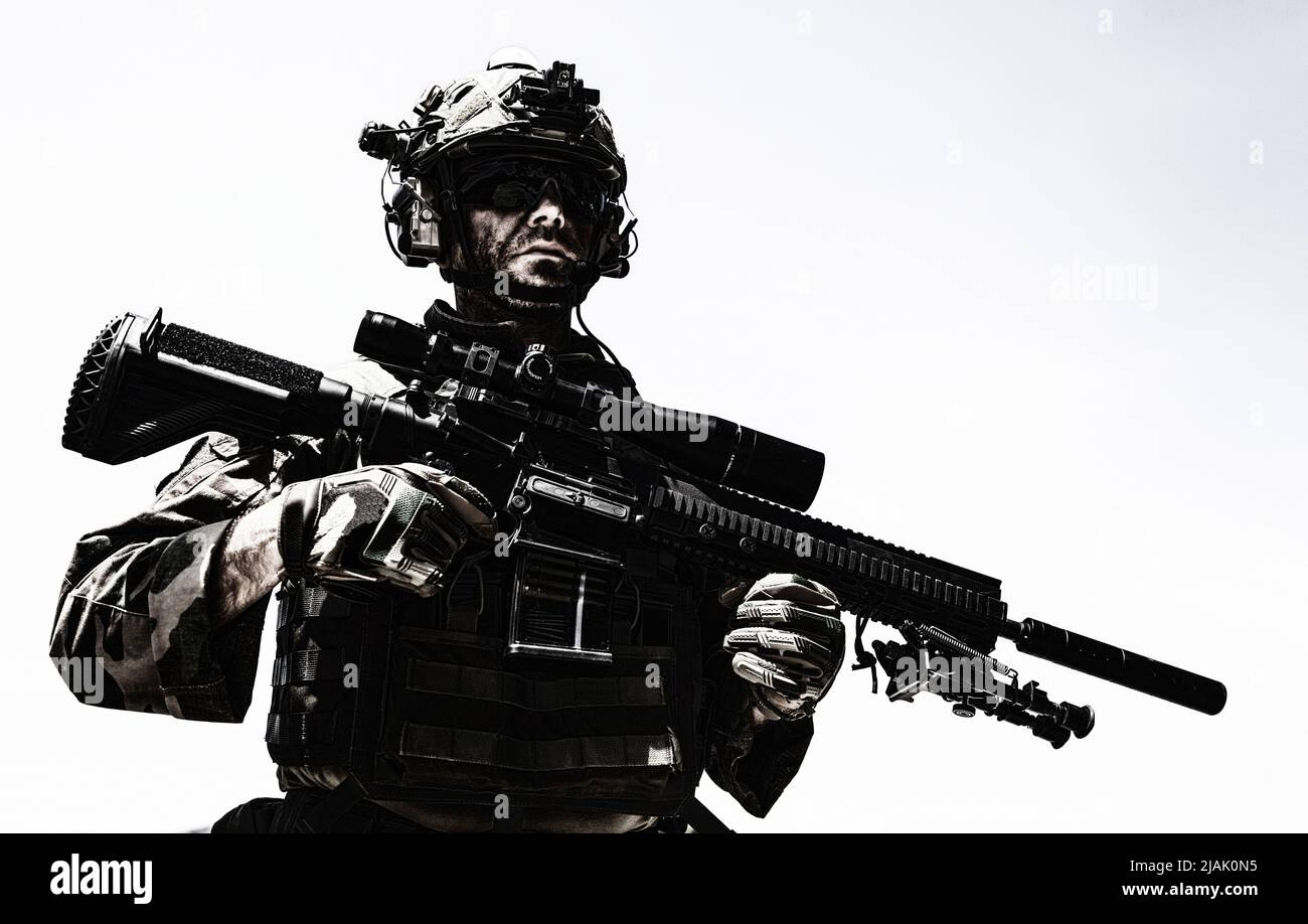Half-length portrait of a soldier holding sniper rifle with optical ...