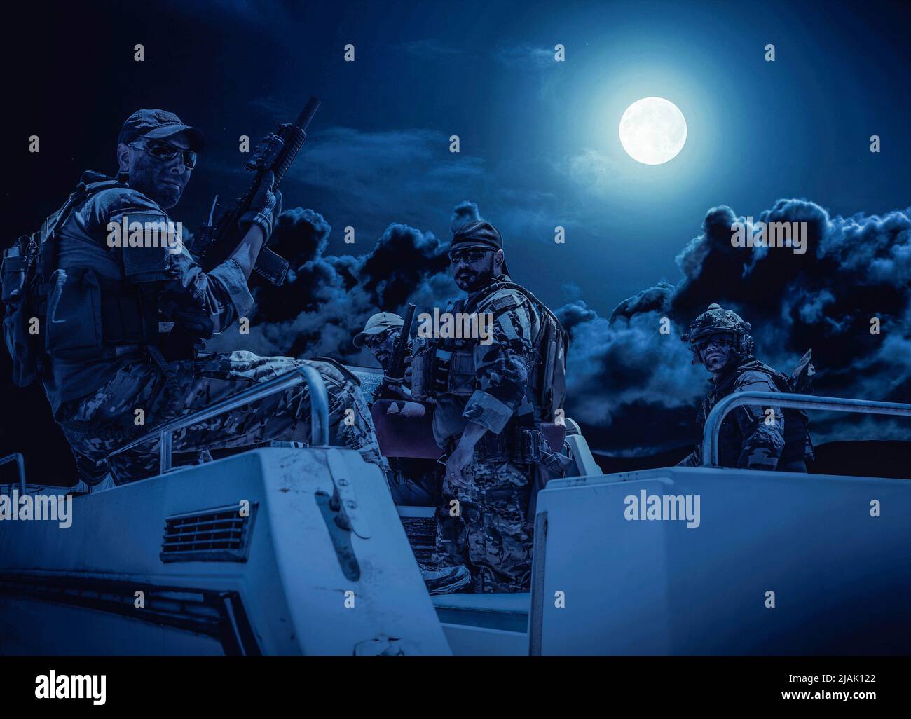 Navy SEALs on a speed boat under a full moon, during a night patrol mission. Stock Photo