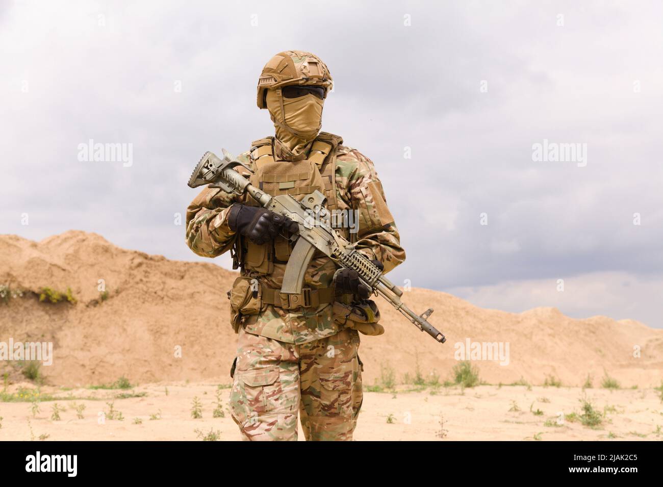 Portrait of a special forces soldier with rifle in the desert. Stock Photo
