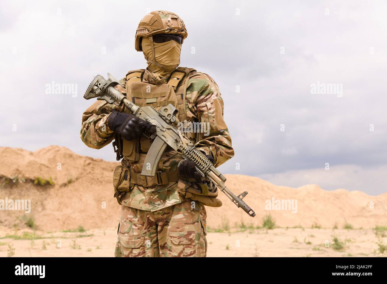 Armed special forces soldier in camouflage holding rifle. Stock Photo