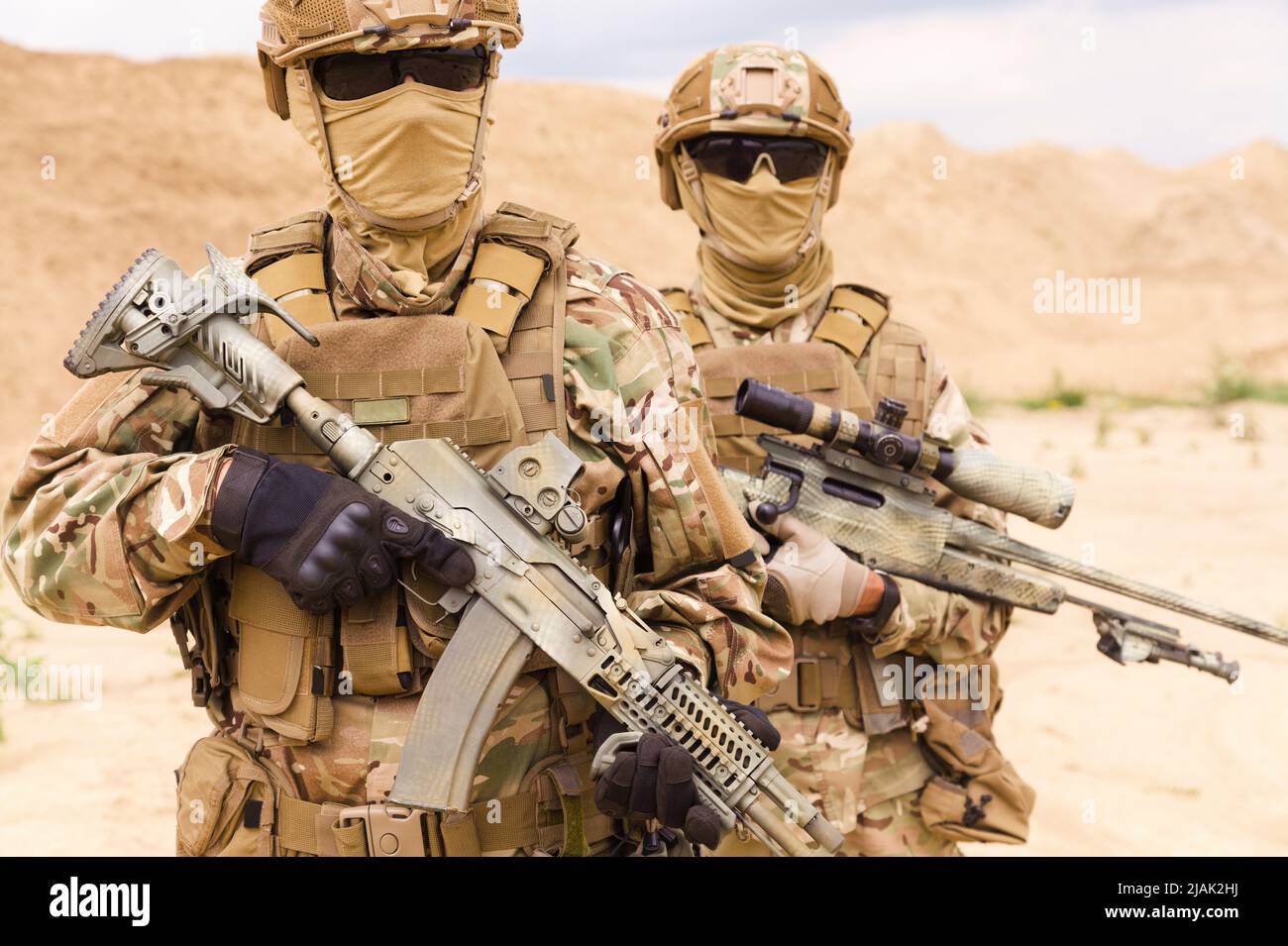 Close-up portrait of equipped and armed special forces soldiers with sniper rifles. Stock Photo
