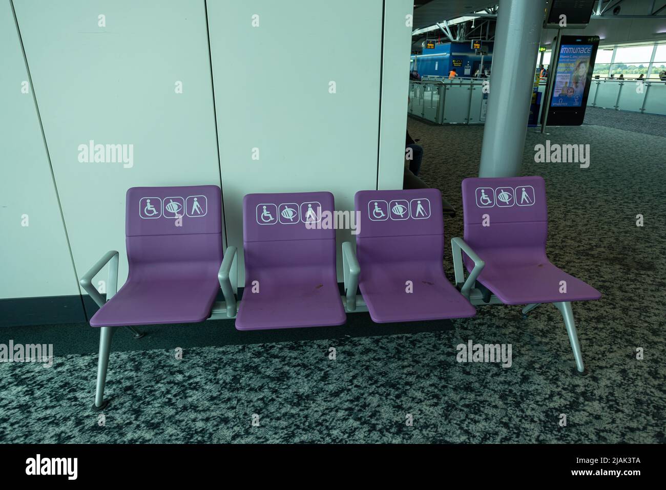 Empty disabled seats at London Stansted airport in waiting area before boarding Stock Photo