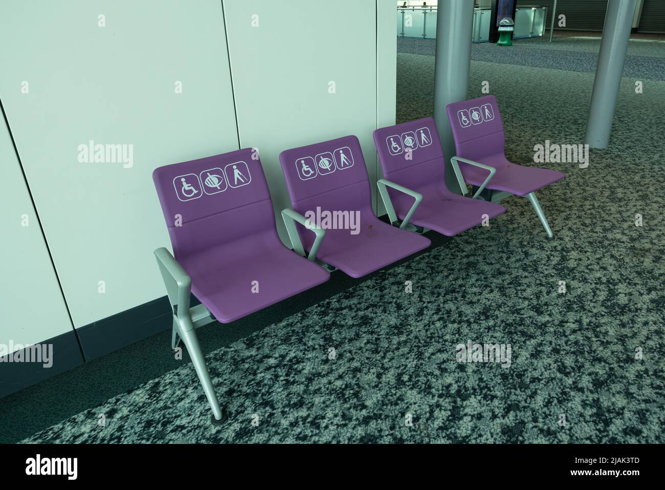 Empty disabled seats at London Stansted airport terminal in waiting area before boarding Stock Photo