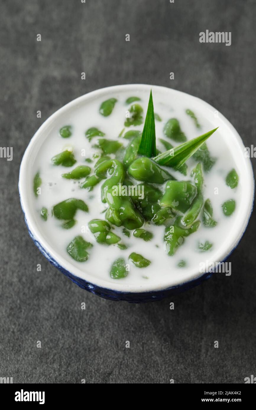 Es Cendol or Dawet is Indonesia Traditional Iced Dessert Made from Rice Flour, Palm Sugar, Coconut Milk and Pandan Leaf Served in a Blue Bowl. Popular Stock Photo