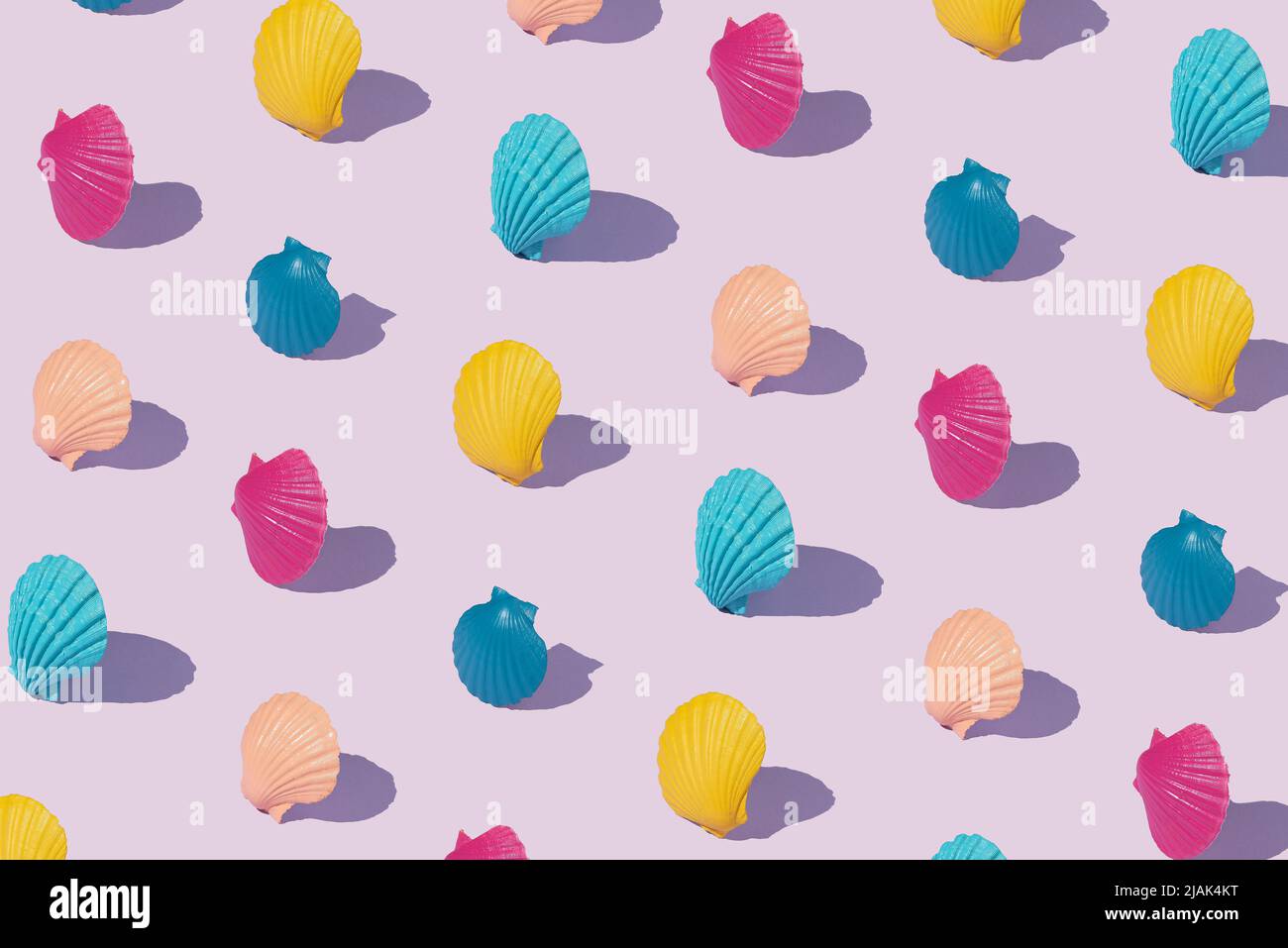 Pattern with multicolored shells on a purple background. Creative summer abstract concept. Isometric rectangle layout. Stock Photo
