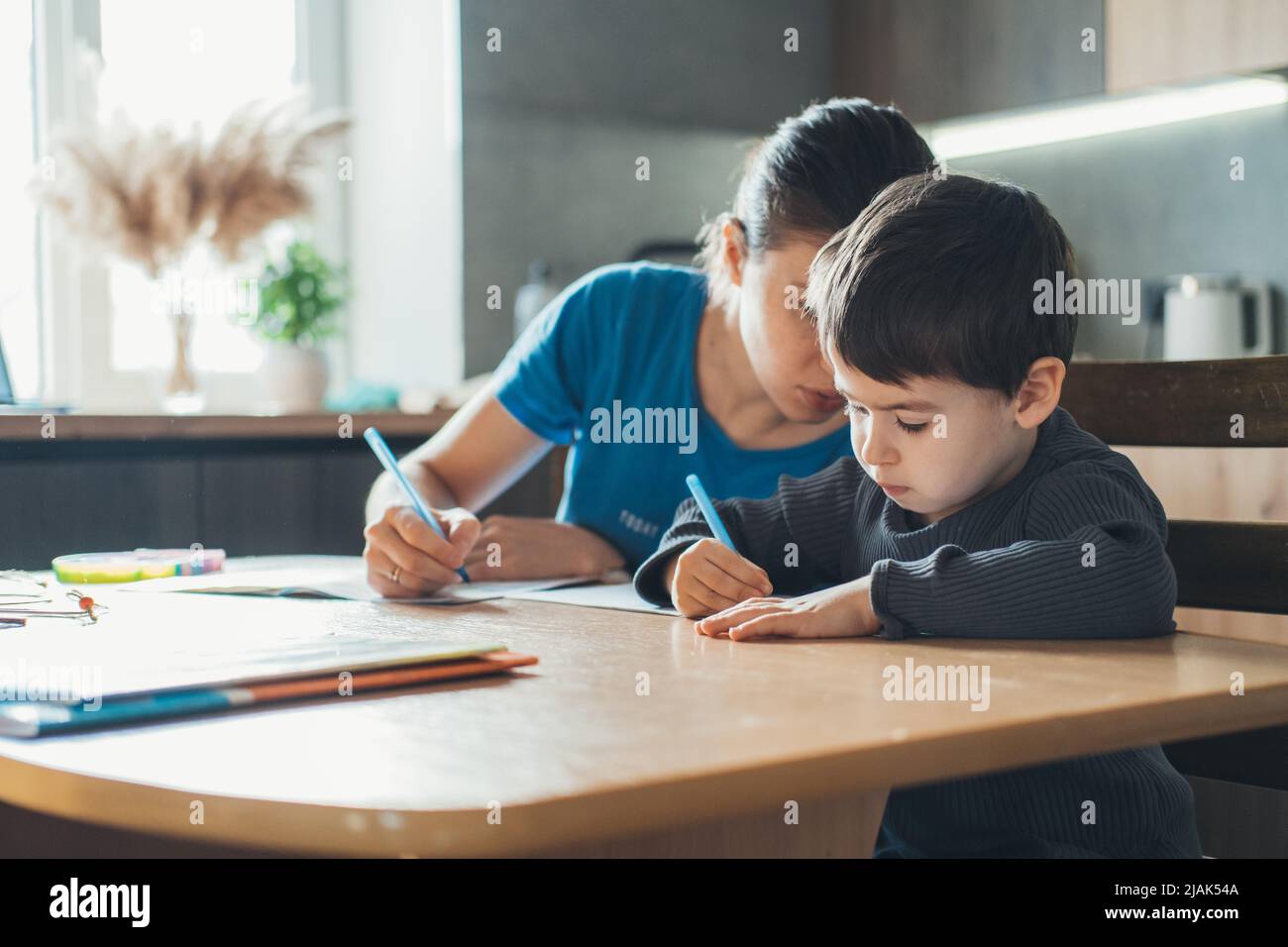 Cute mother son doing homework hi-res stock photography and images - Alamy