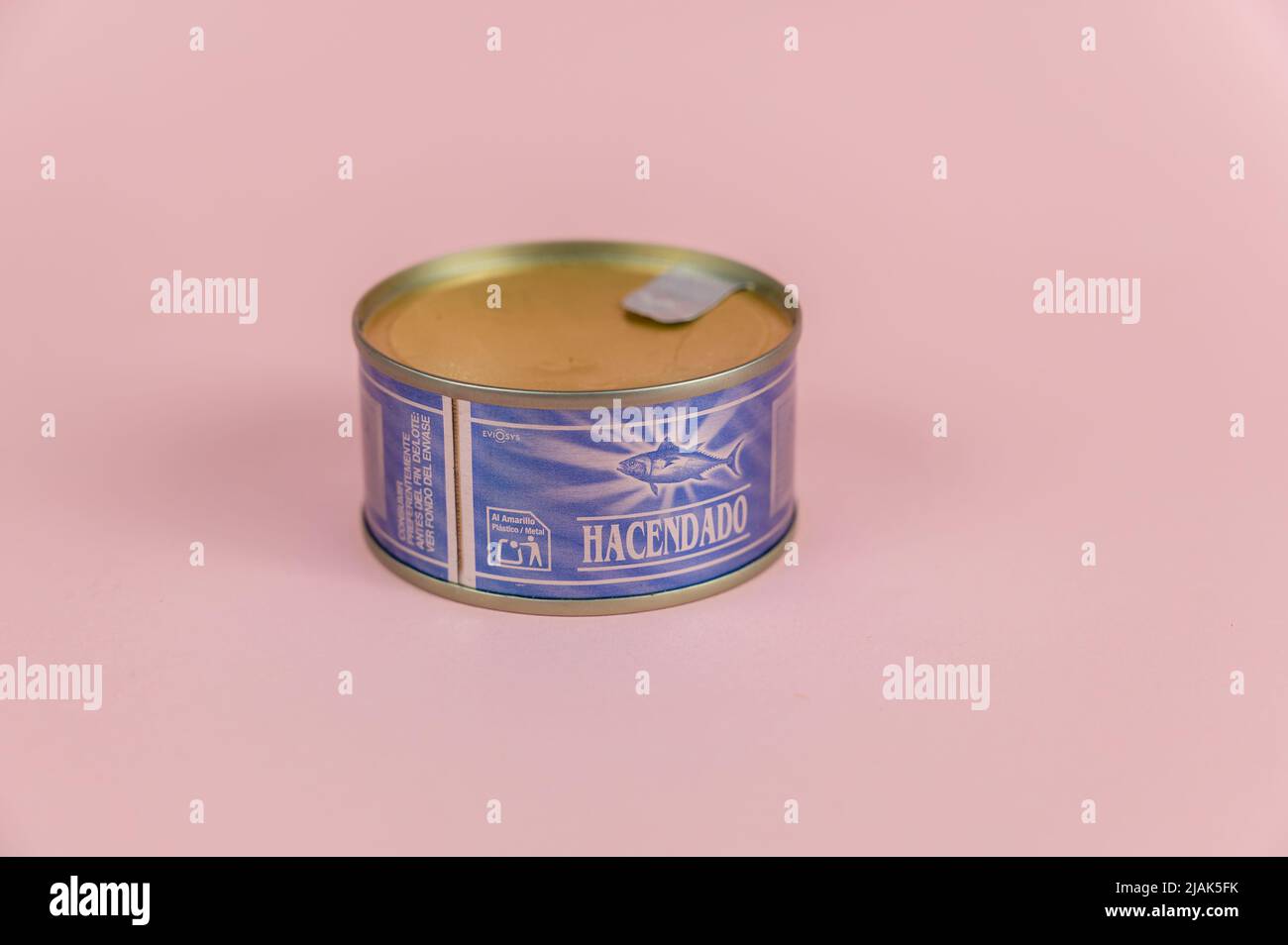 A blue tin can against a pink background. A tin of canned tuna in oil. Spanish manufacturer