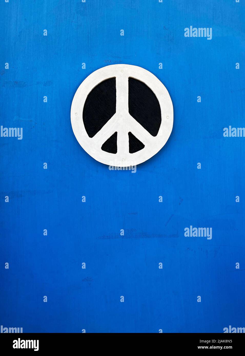 A carved peace sign on a blue background Stock Photo
