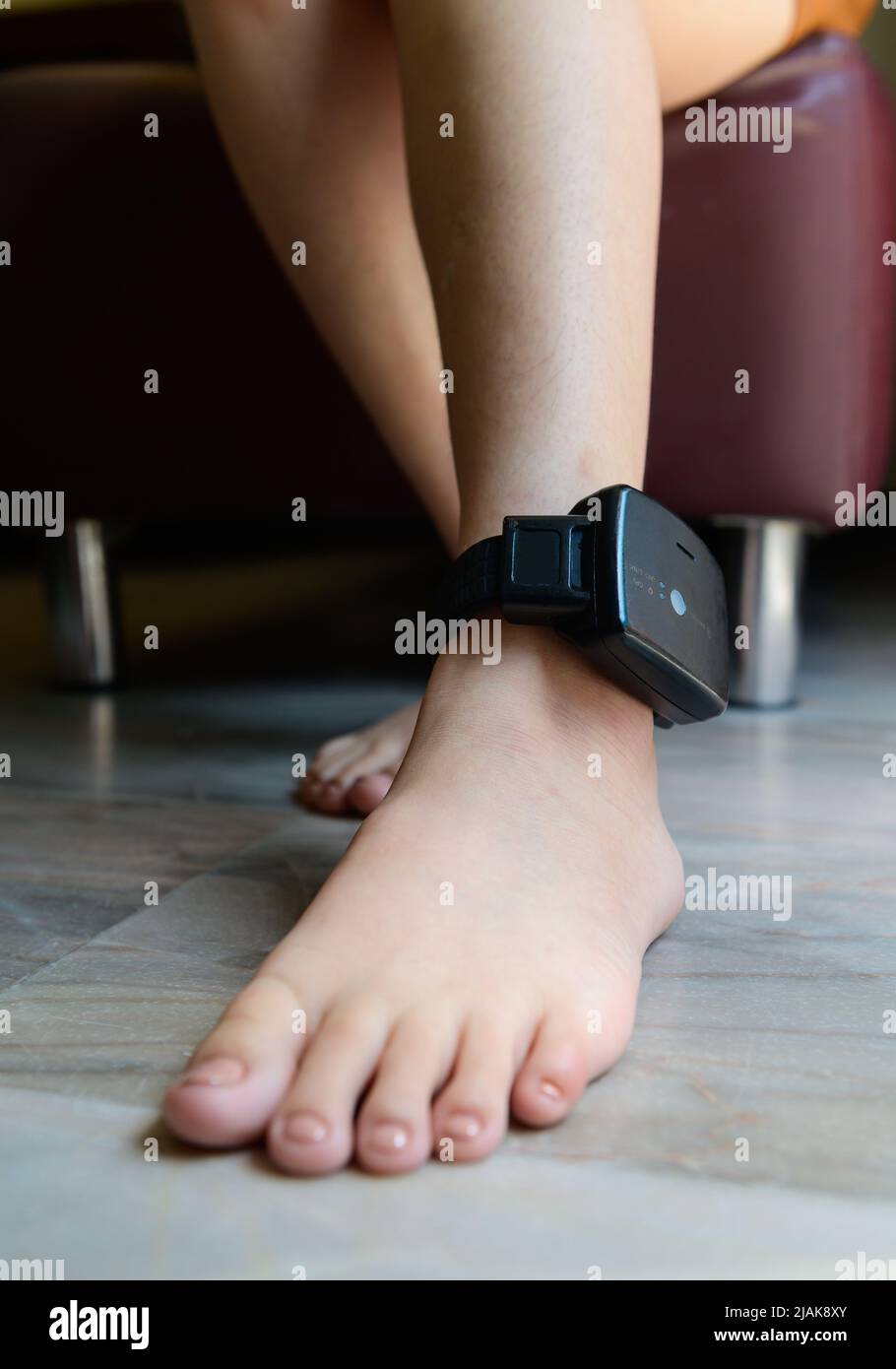 Prisoner is attached to an electronic monitoring on ankle Stock Photo