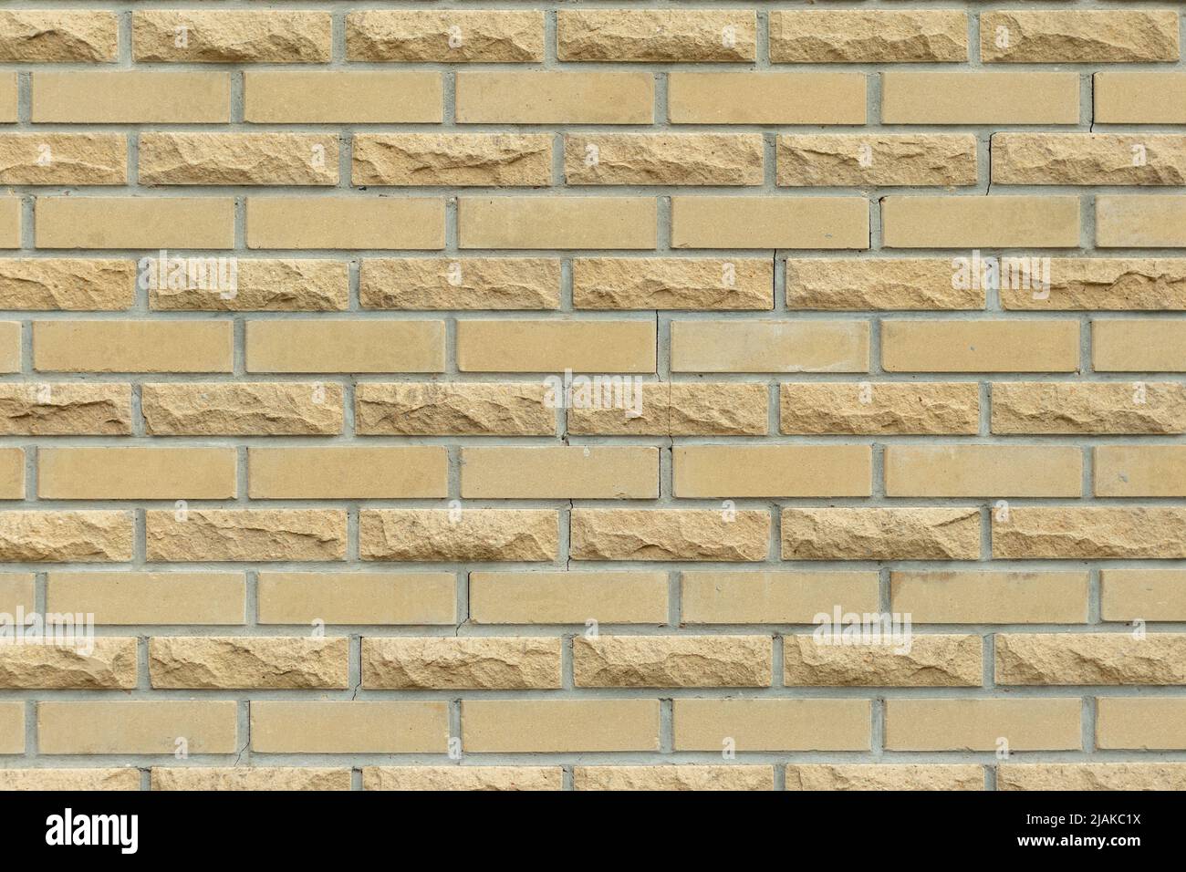 Solid yellow and beige brick wall. Brick background. Stock Photo