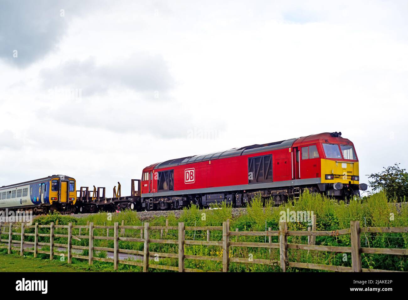 Northern Train passing DB Shenker class 60 on a freight from Skinningrove, Moorhouses, Stockton on Tees, Cleveland, England Stock Photo