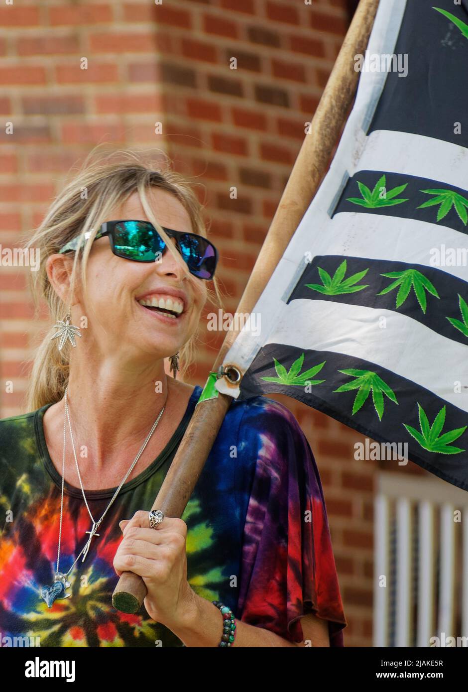 Marijuana legalization advocate and 'Canna Sense Campaign' co-founder Stacey Shepherd Theis carries a flag covered with marijuana leaves at the 141st Fancy Farm Picnic on Saturday, Aug. 7, 2021 in Fancy Farm, Graves County, KY, USA. Theis has said her uncle, Gary Shepherd, was a marijuana grower shot and killed by Kentucky State Police in a 1993 Rockcastle County drug raid in which police attempted to destroy 12 cannabis plants. (Apex MediaWire Photo by Joel Wolford) Stock Photo